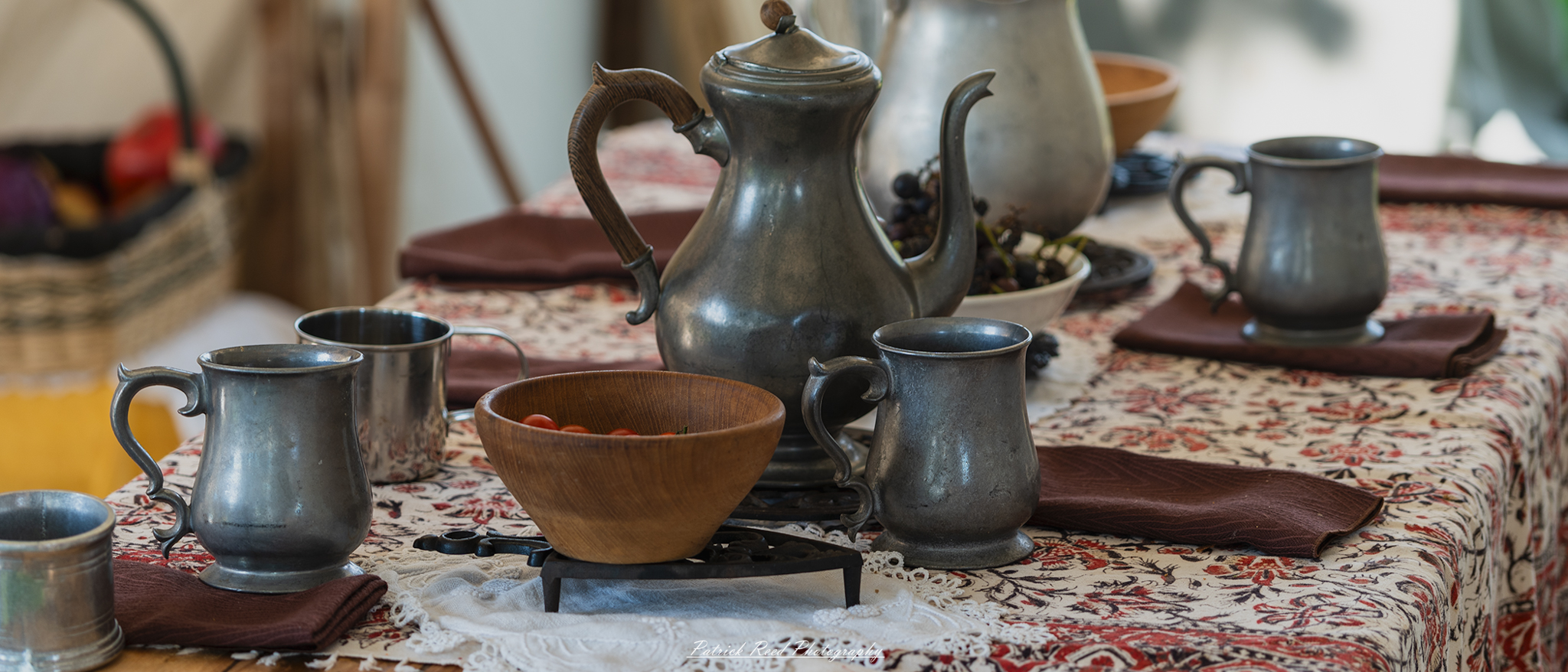 A neatly arranged table setting, featuring elegant dinnerware including plates, silverware, glasses, and folded napkins. The table is set with attention to detail, perhaps adorned with a tablecloth and centerpiece, creating a polished and inviting atmosphere for a meal or gathering.